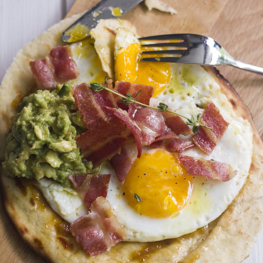 Naan Bread Topped with Fried Eggs and Accompaniments